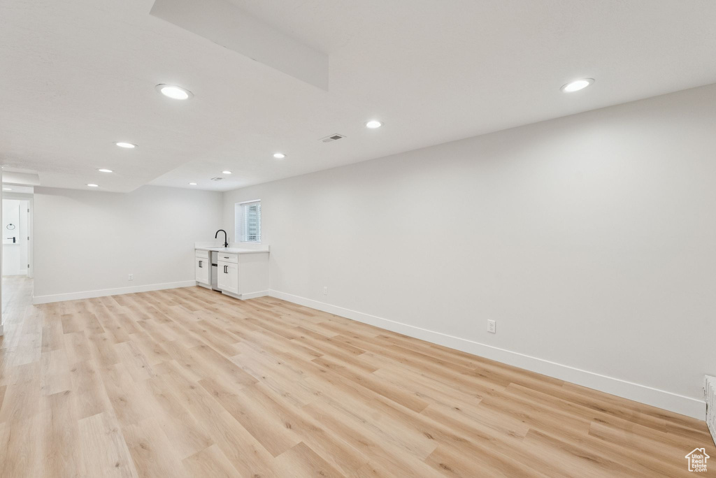Below grade area with recessed lighting and light wood-type flooring