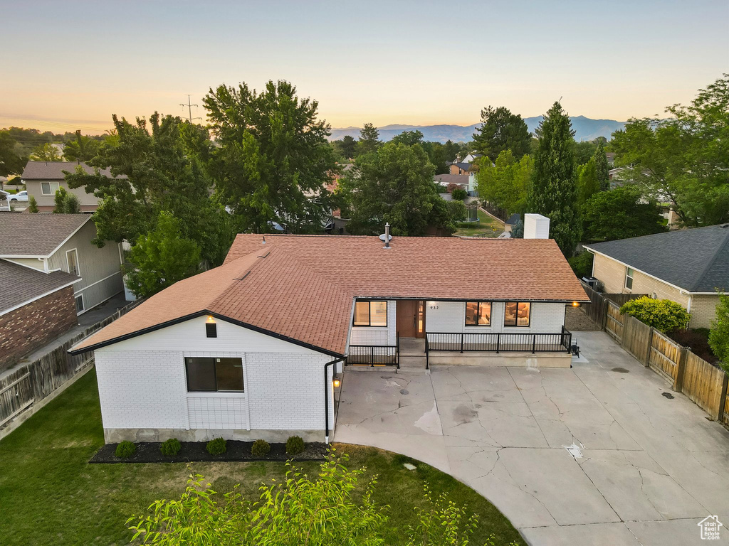 Back of property featuring roof with shingles