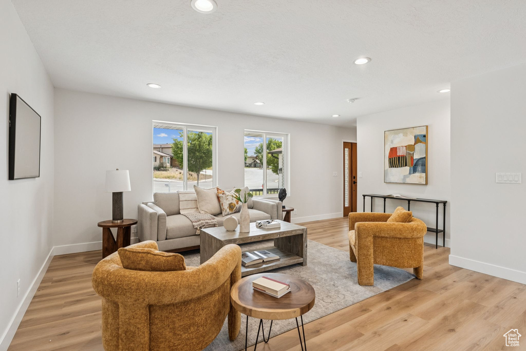 Living area featuring light wood-style flooring and recessed lighting