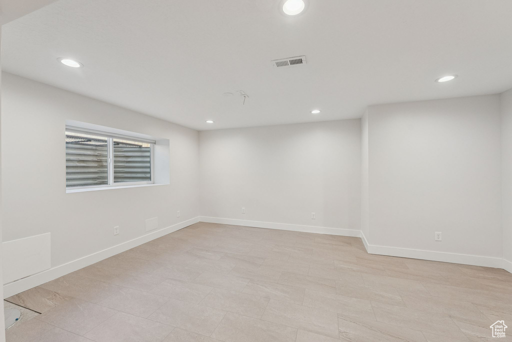 Unfurnished room featuring recessed lighting and baseboards