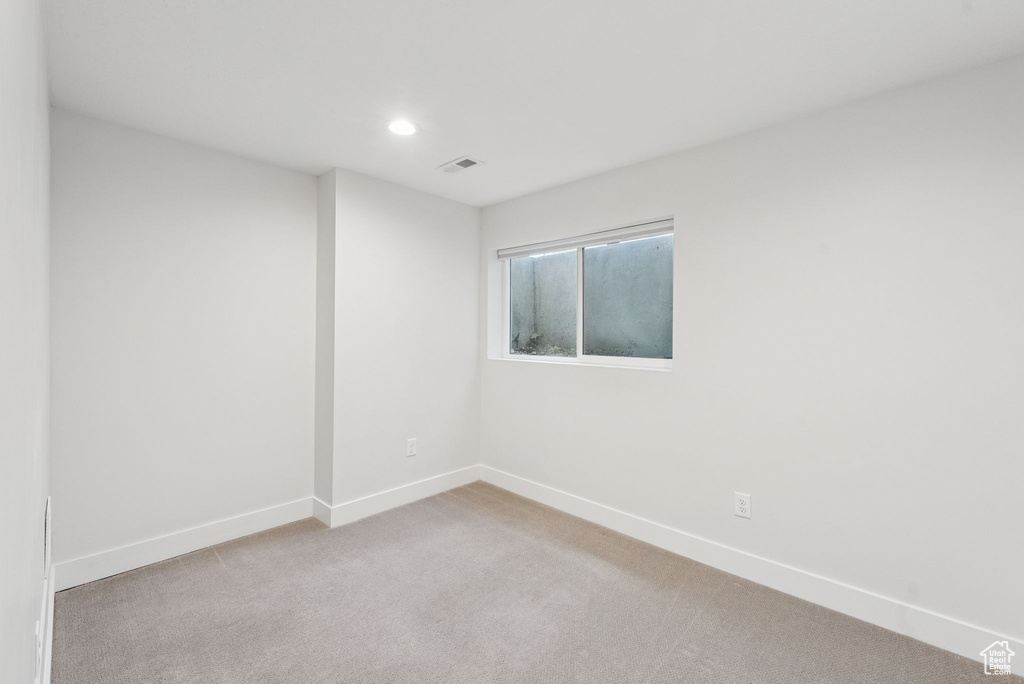 Unfurnished room featuring light carpet and recessed lighting