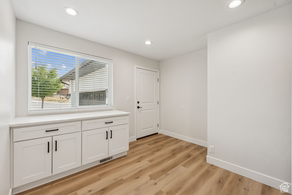 Interior space with light wood-style flooring and recessed lighting