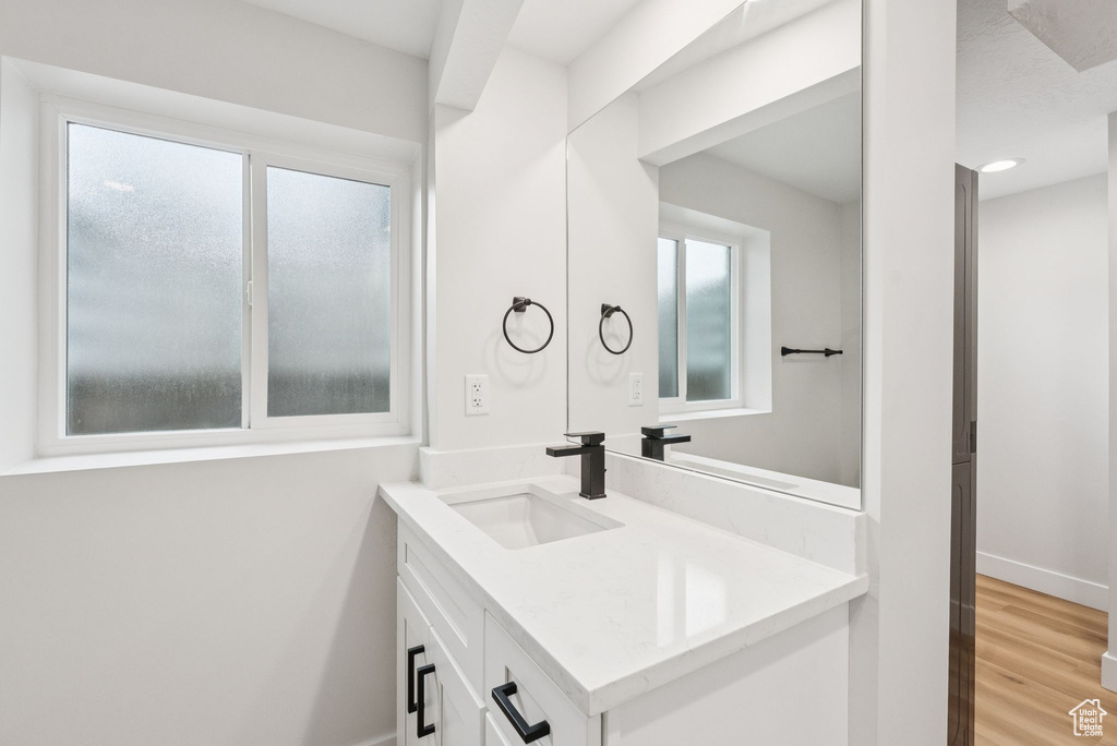 Bathroom with vanity and wood finished floors