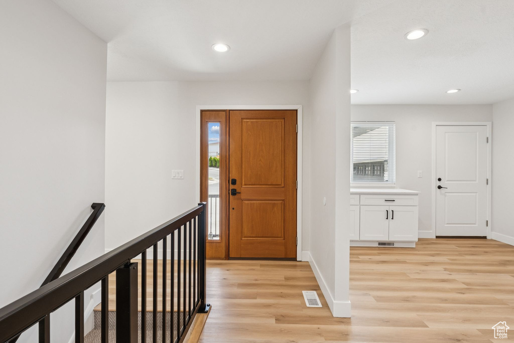 Foyer entrance with light wood-type flooring, plenty of natural light, and recessed lighting