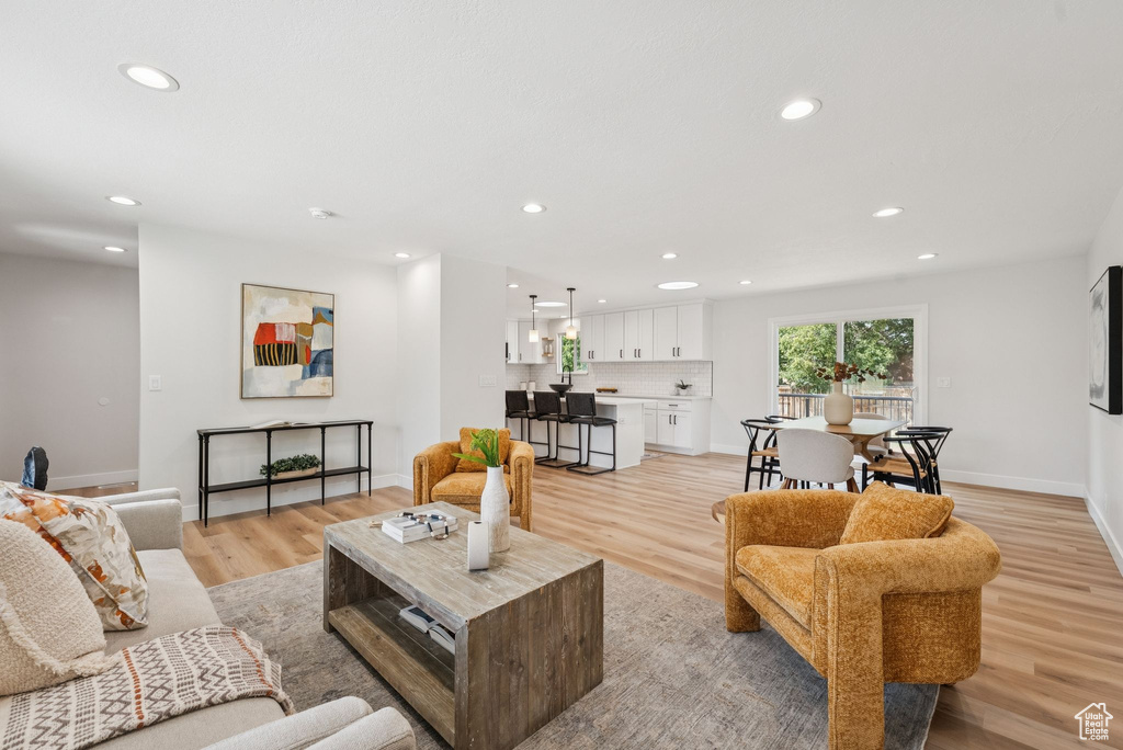 Living area featuring recessed lighting and light wood-style flooring
