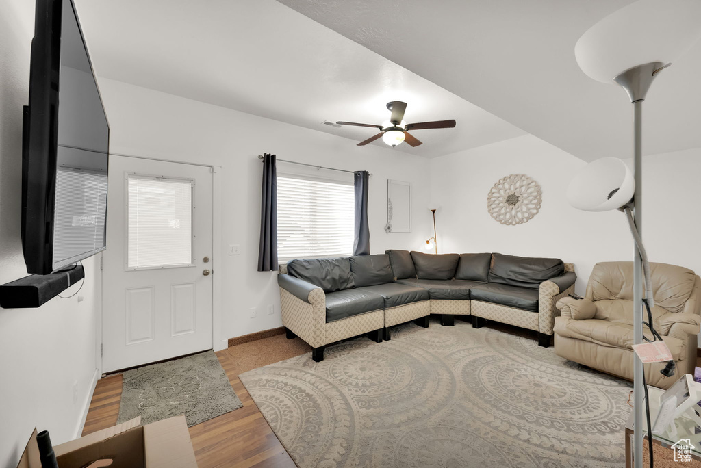 Living area featuring ceiling fan and wood finished floors