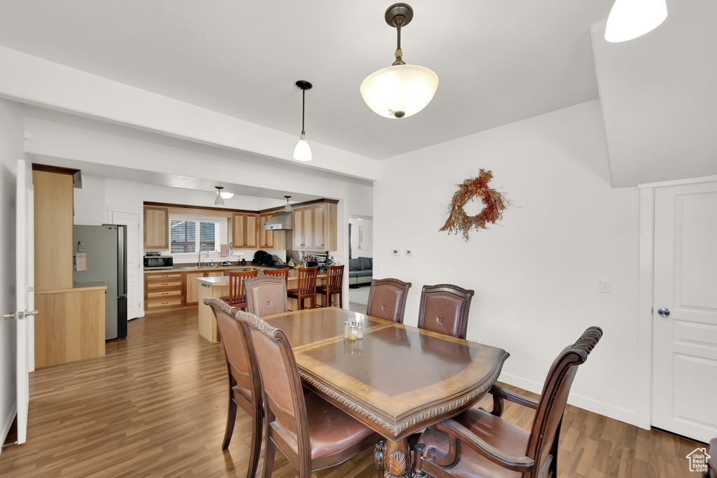 Dining room with dark wood-style flooring