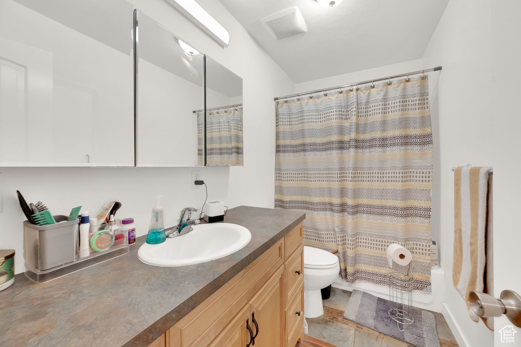 Full bathroom with vanity and a shower with shower curtain