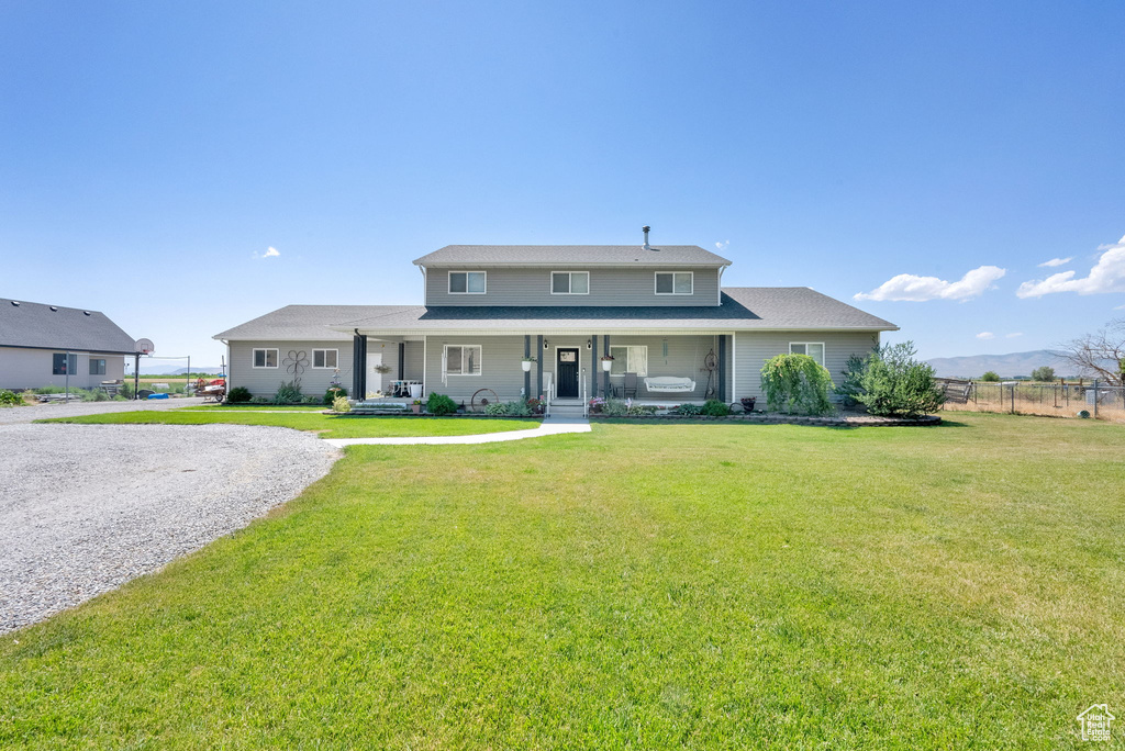View of front facade with a porch and driveway
