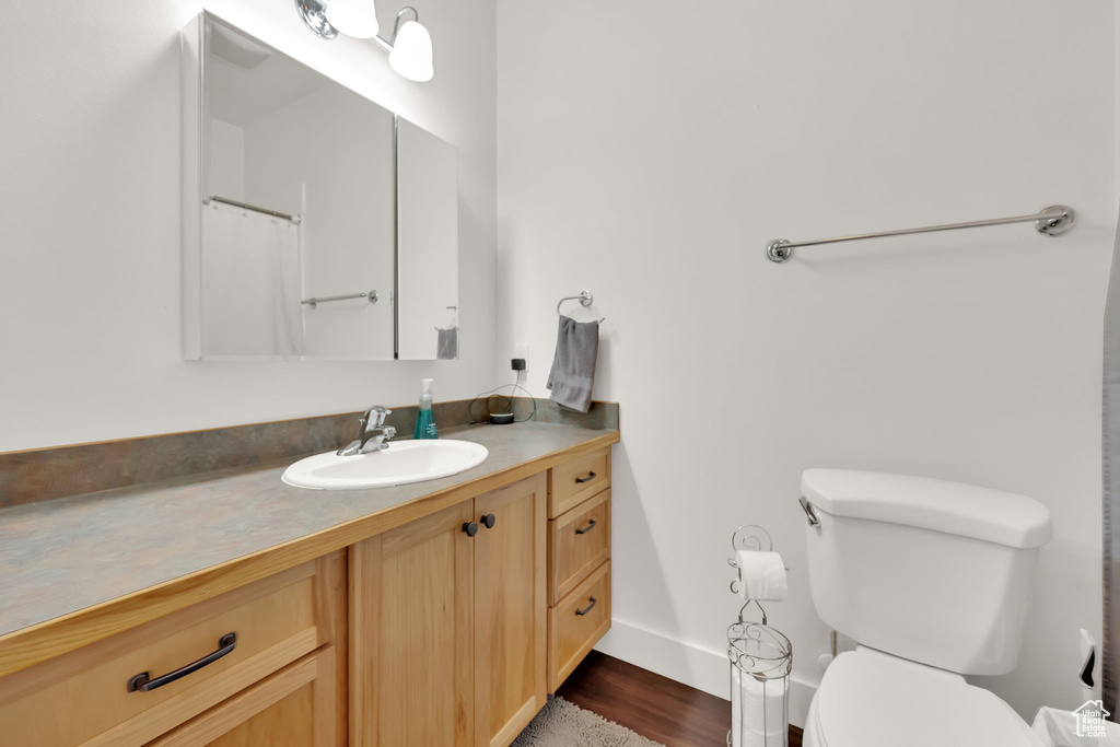Bathroom featuring vanity and wood finished floors