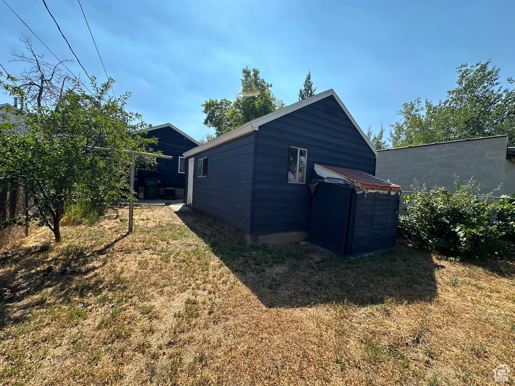 View of property exterior with a yard