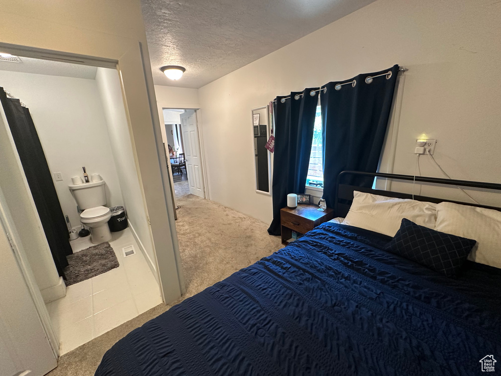 Bedroom with carpet flooring and a textured ceiling