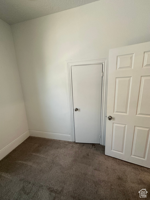 Carpeted spare room with baseboards