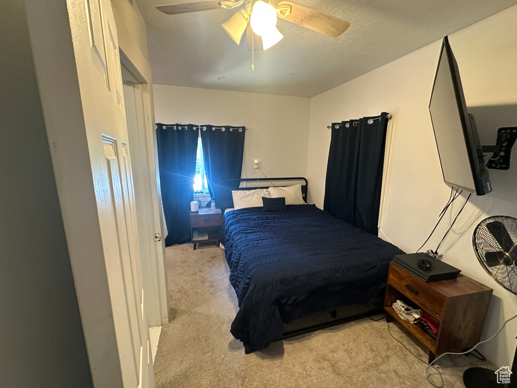Bedroom with carpet and a ceiling fan