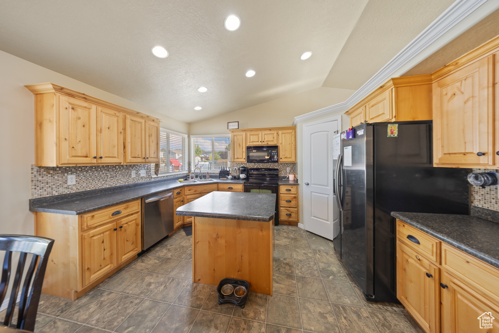 Kitchen with black appliances, lofted ceiling, a center island, dark countertops, and decorative backsplash