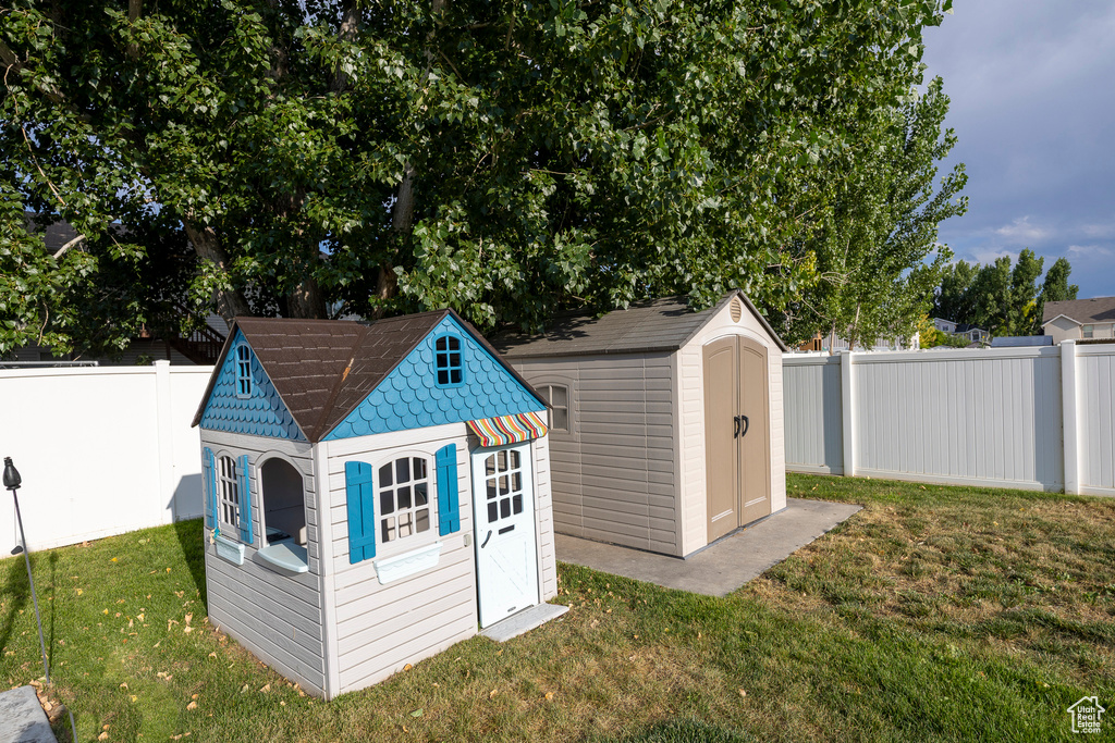 View of shed with a fenced backyard