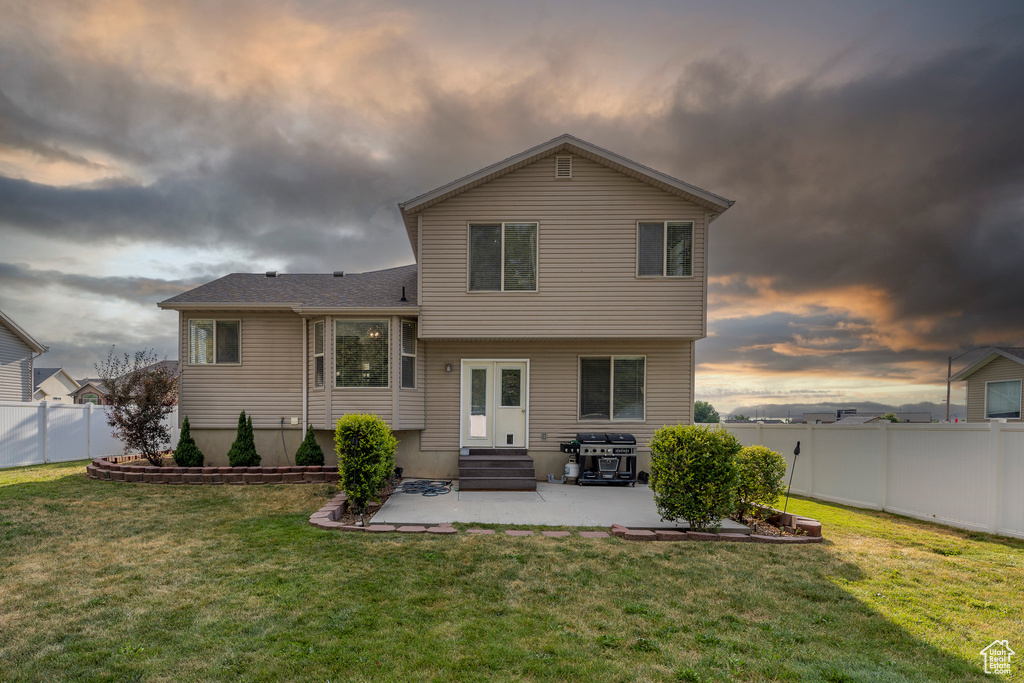 Back of property featuring a patio area, a fenced backyard, and entry steps