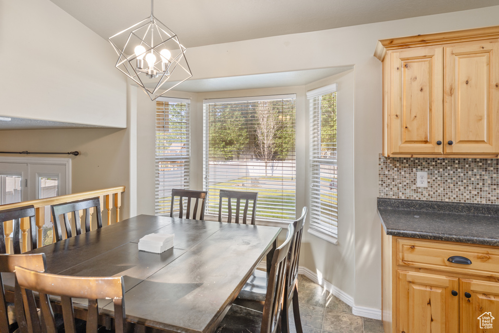 Dining room featuring a chandelier and stone finish flooring