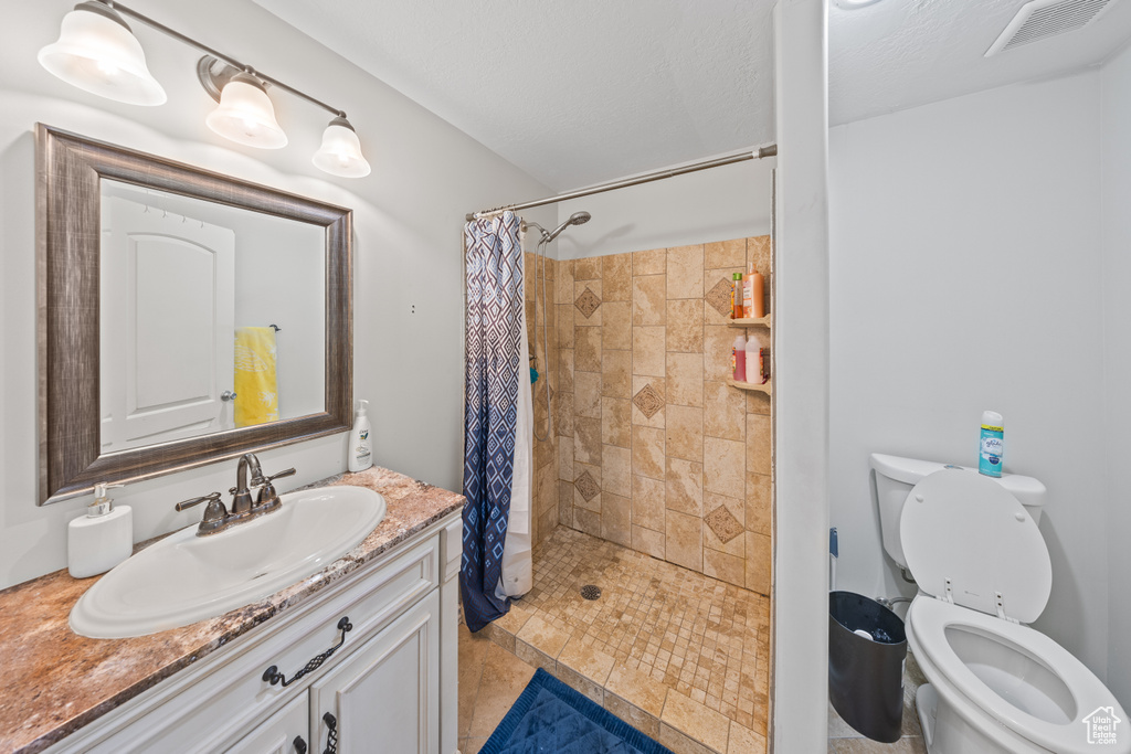Bathroom featuring vanity and a tile shower