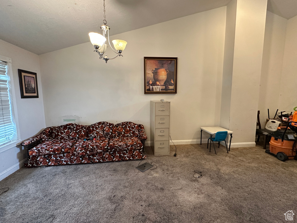 Sitting room featuring lofted ceiling, carpet flooring, a chandelier, and healthy amount of natural light