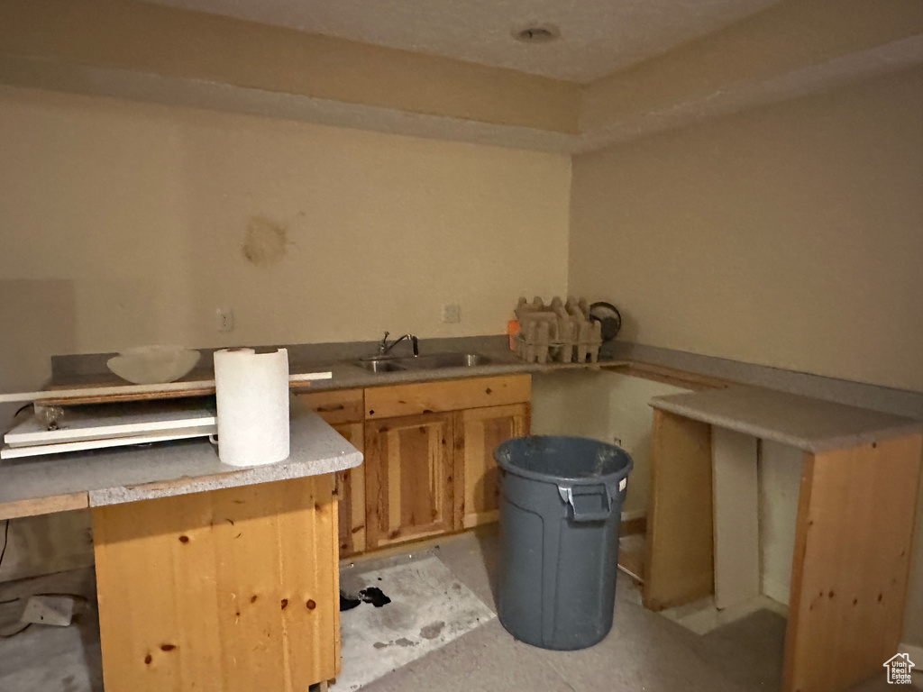 Kitchen featuring a sink and light countertops