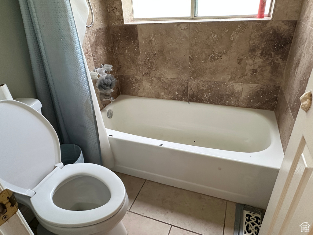Full bathroom with shower / tub combo and tile patterned floors
