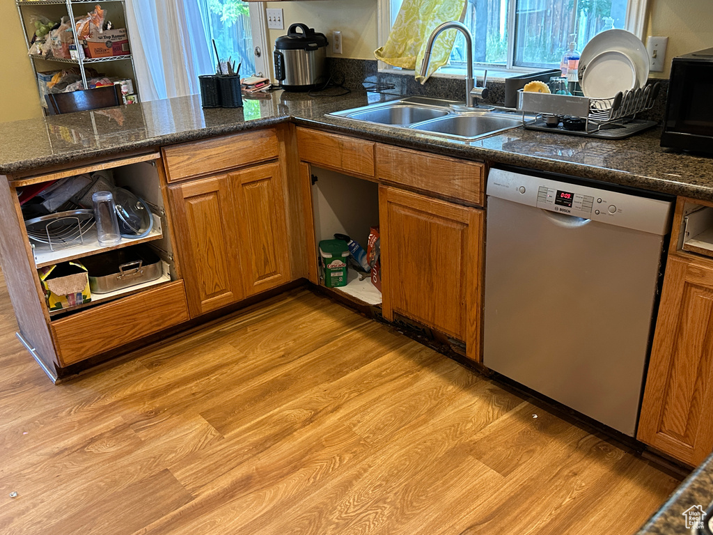 Kitchen with dishwasher, brown cabinetry, and open shelves