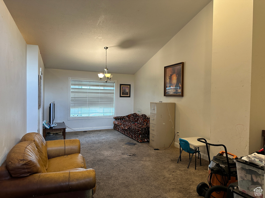 Living area with carpet and lofted ceiling