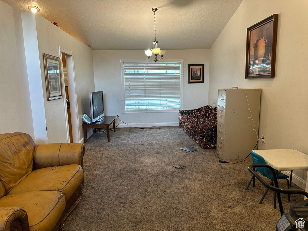 Sitting room with carpet floors and a chandelier
