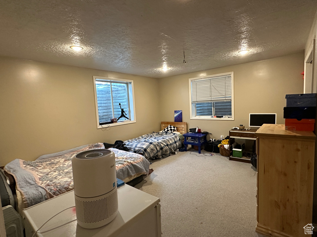 Bedroom featuring a textured ceiling and carpet flooring