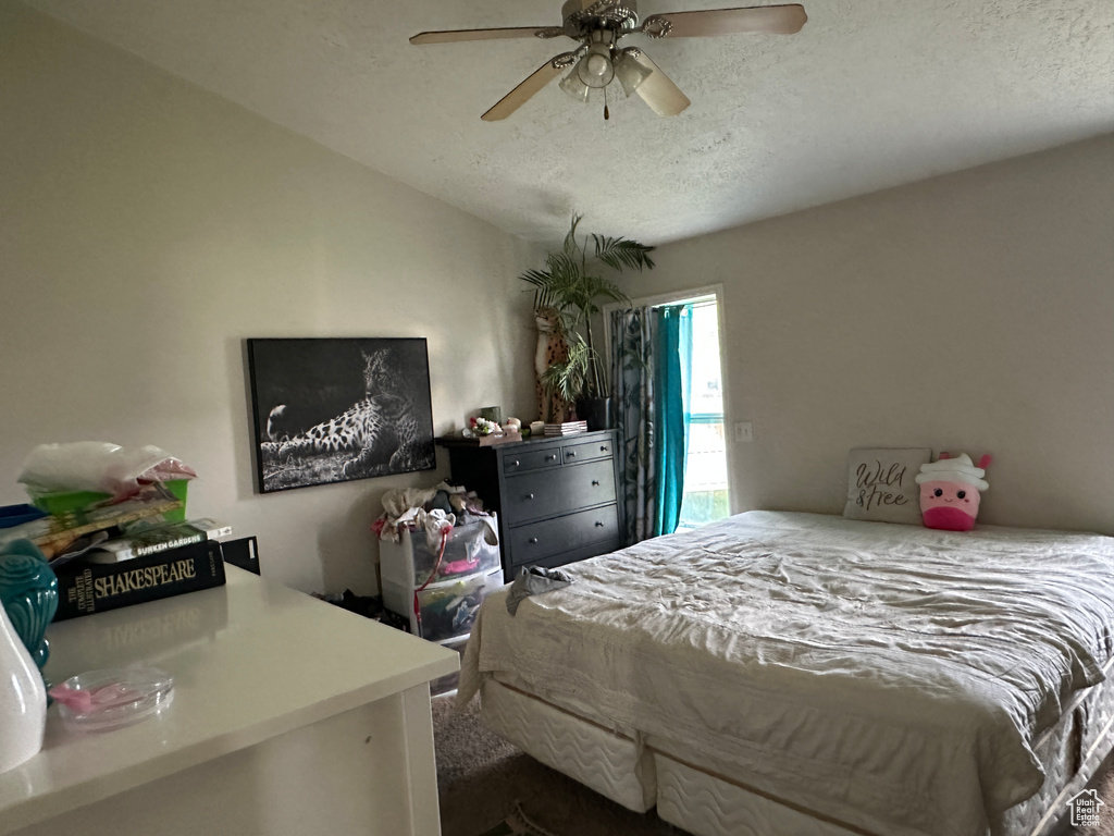 Bedroom featuring a textured ceiling and a ceiling fan