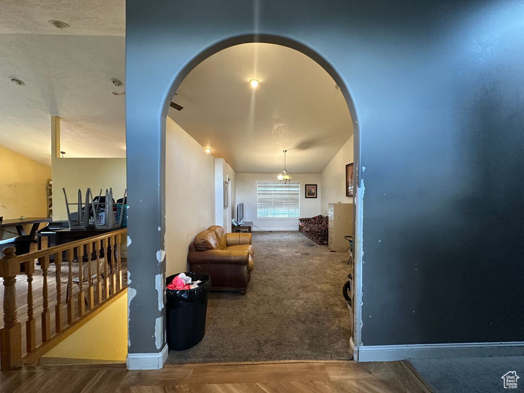 Hall featuring arched walkways and carpet