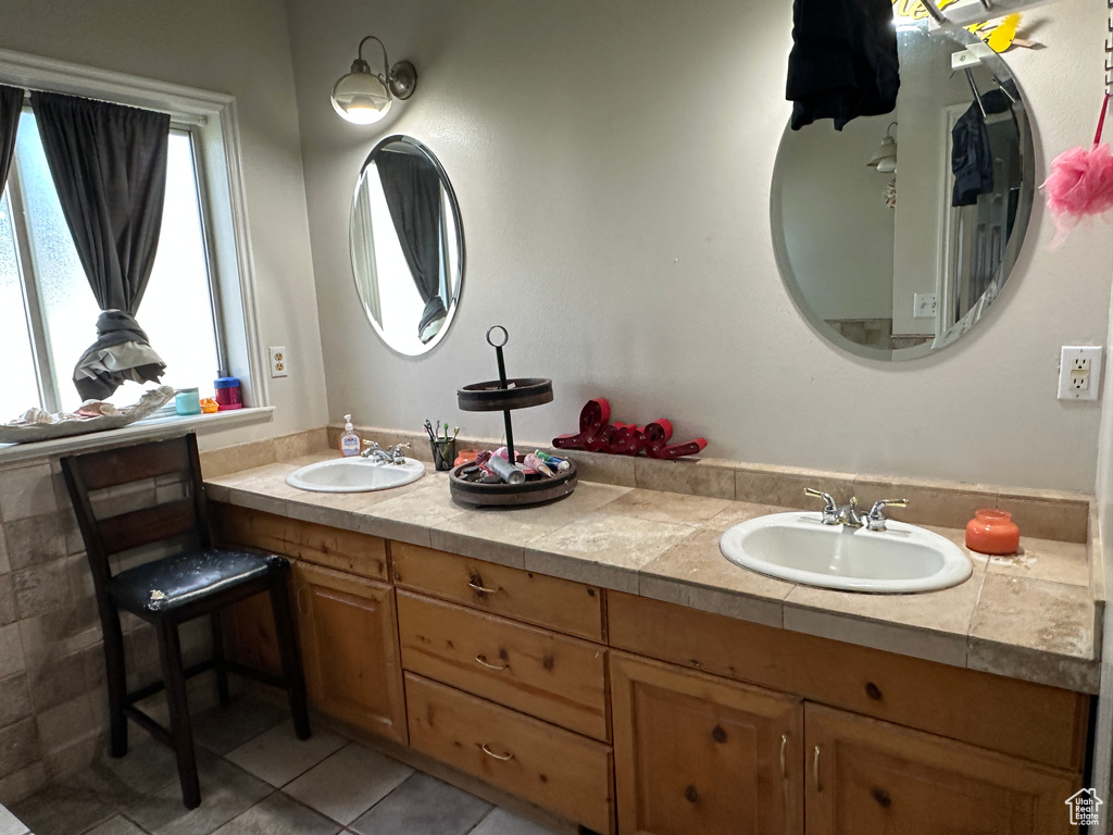 Bathroom with tile patterned flooring and double vanity