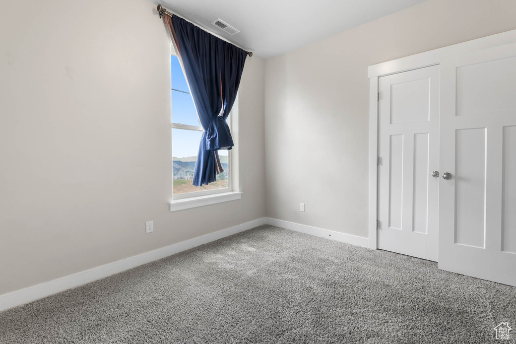Spare room with carpet floors and baseboards