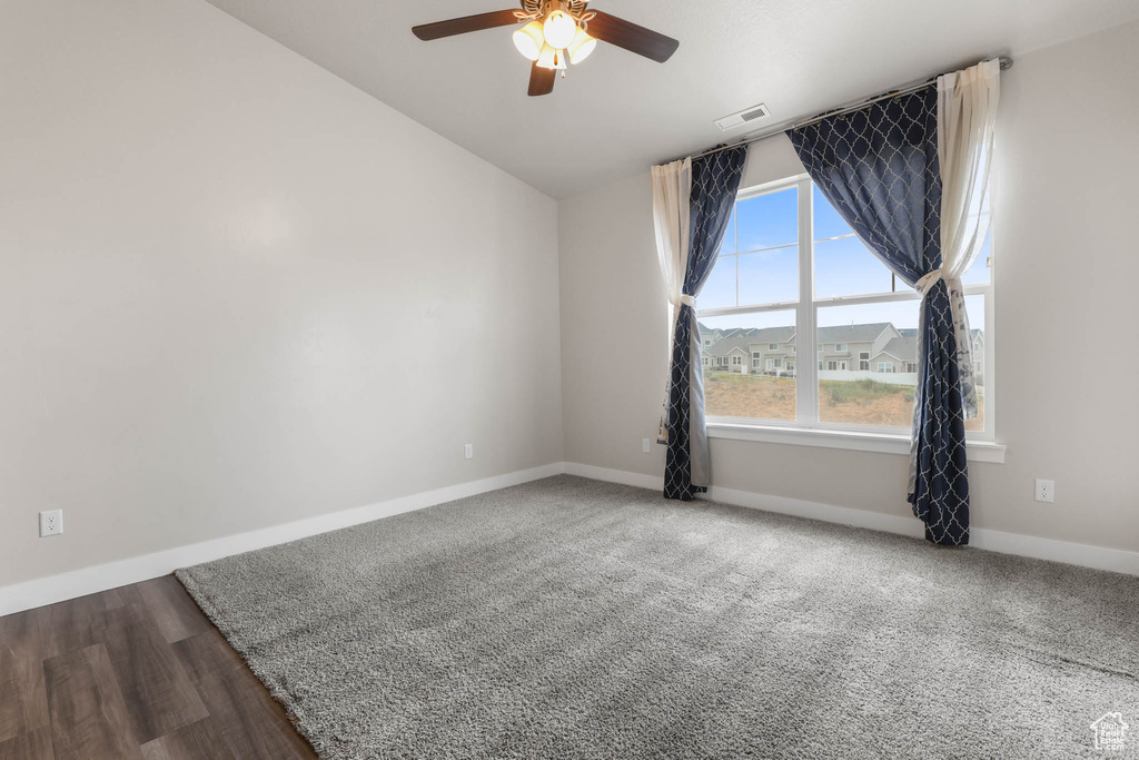 Spare room with a ceiling fan and lofted ceiling