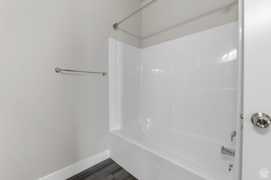 Full bath featuring shower / bathtub combination and wood finished floors