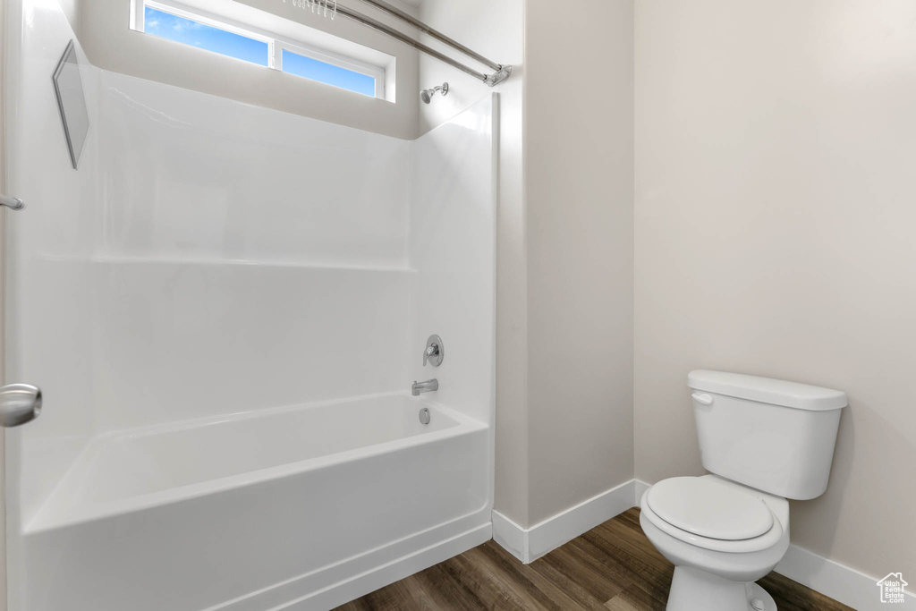 Full bathroom featuring wood finished floors and shower / bathtub combination
