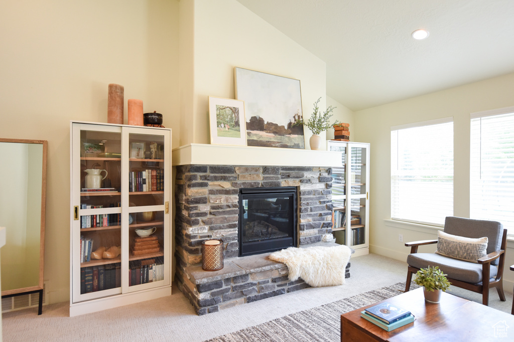 Living area featuring vaulted ceiling, carpet, a fireplace, and recessed lighting