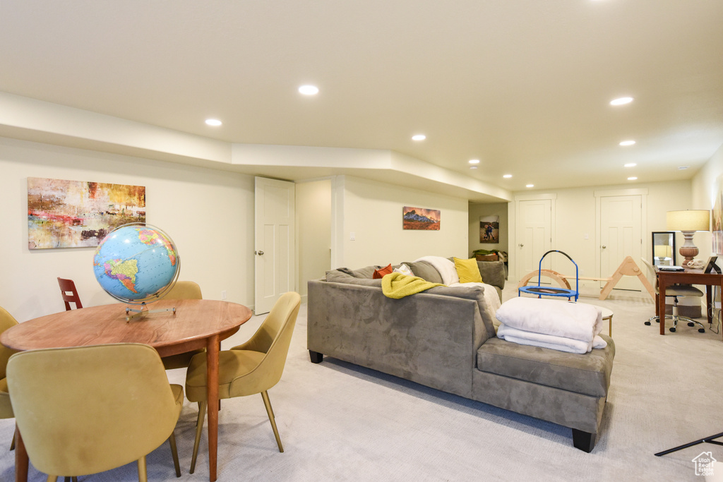 Living area featuring light colored carpet and recessed lighting