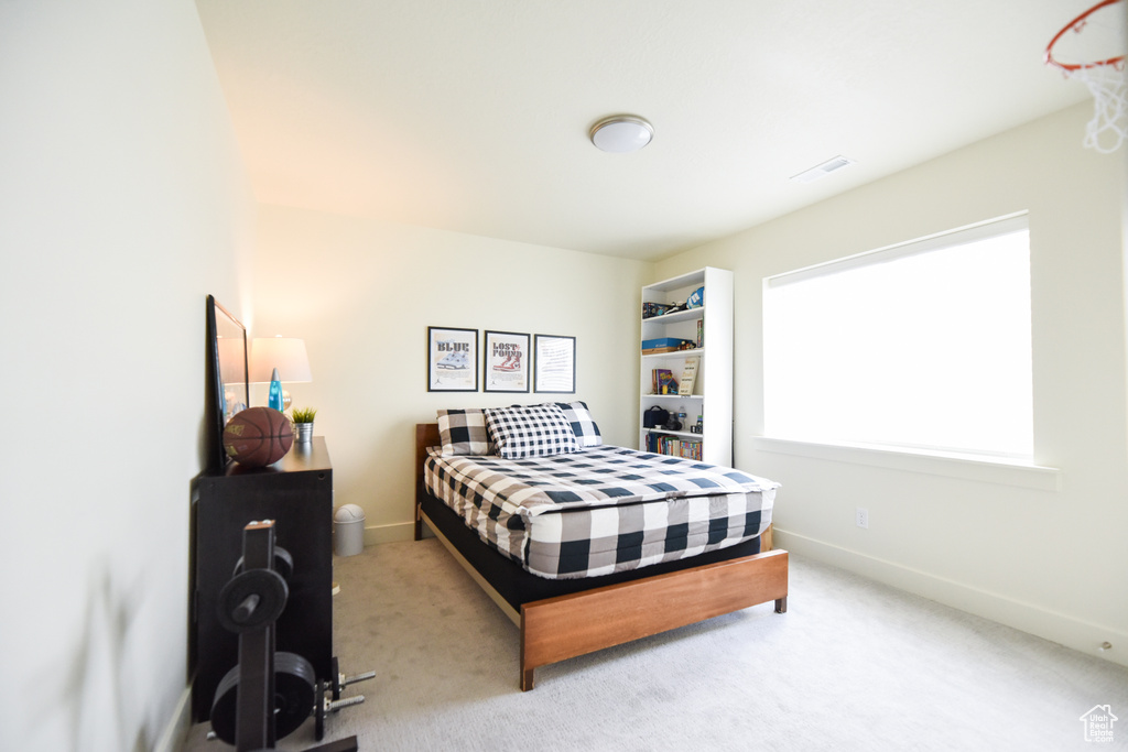 Carpeted bedroom featuring baseboards