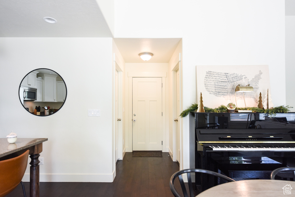 Hall featuring dark wood-style floors and baseboards
