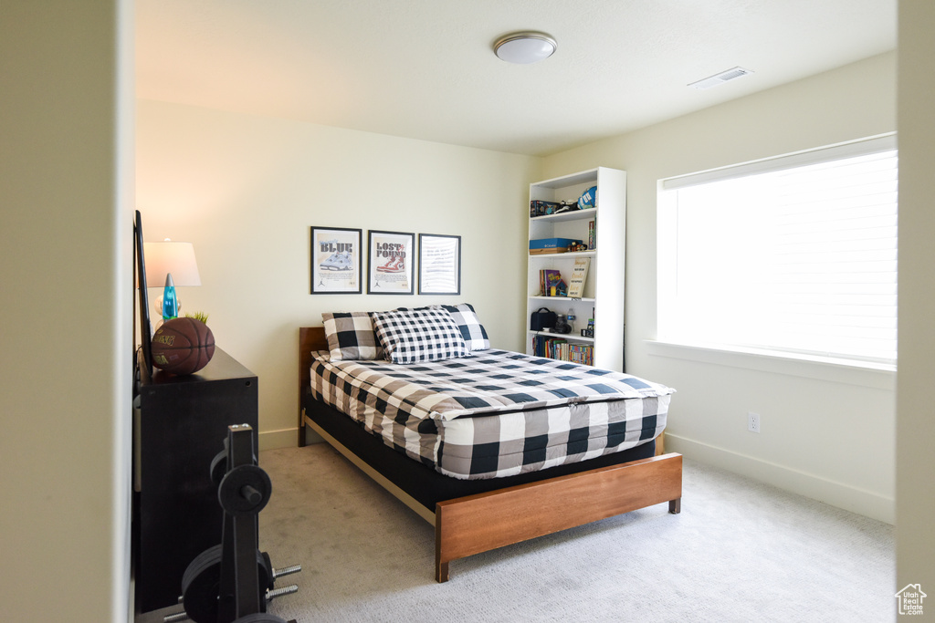 Carpeted bedroom with baseboards