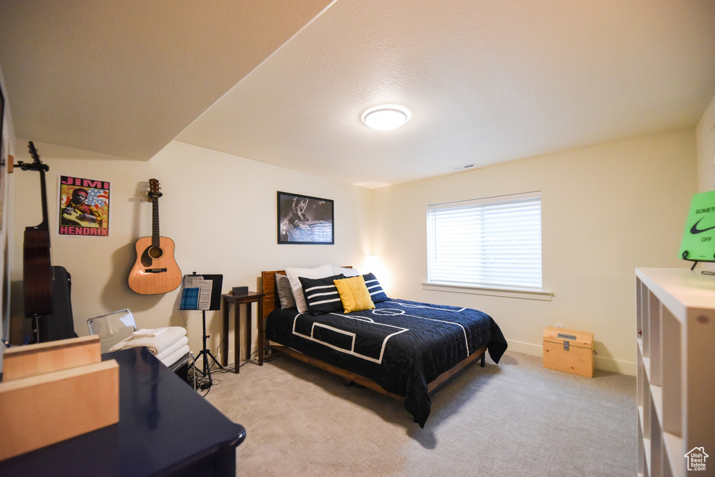 Bedroom with light colored carpet