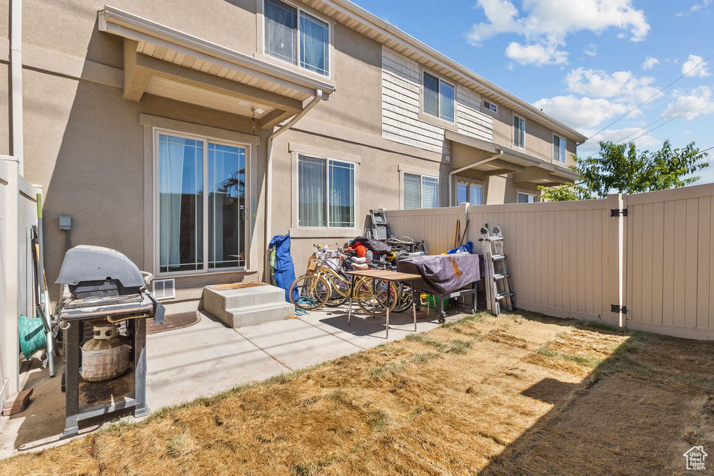 Back of house featuring a patio area, stucco siding, and entry steps