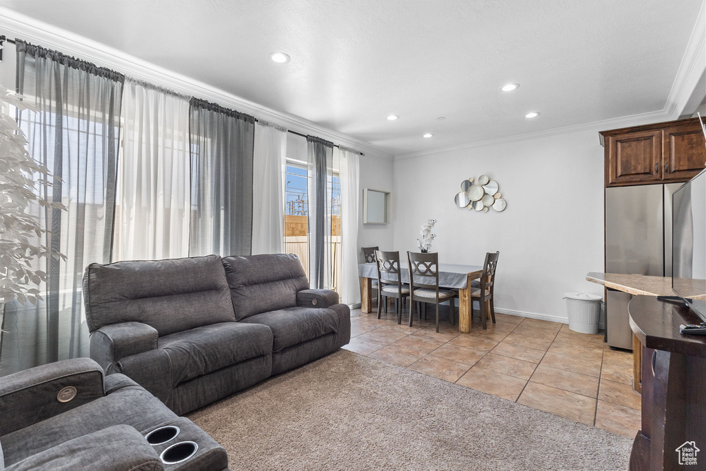Living room with crown molding, light tile patterned floors, and recessed lighting