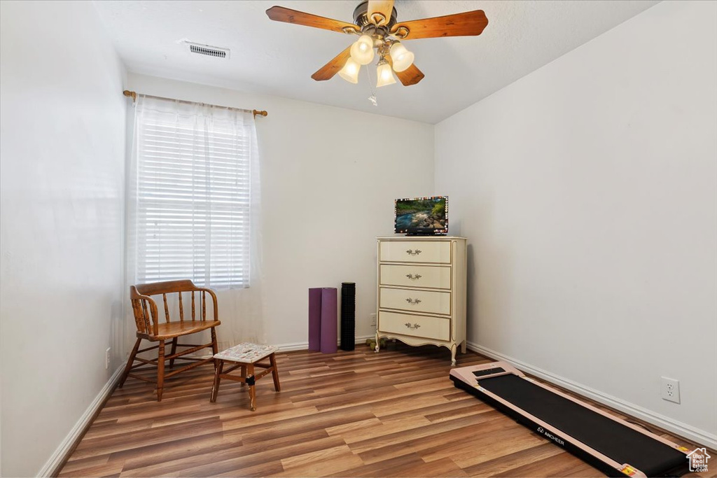 Sitting room featuring light wood finished floors and a ceiling fan