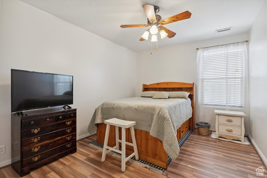 Bedroom with wood finished floors and a ceiling fan