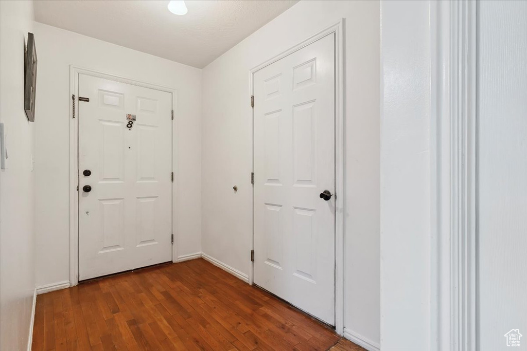 Entrance foyer with wood finished floors and baseboards