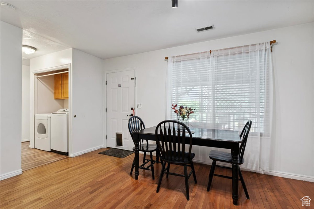 Dining space featuring independent washer and dryer and wood finished floors