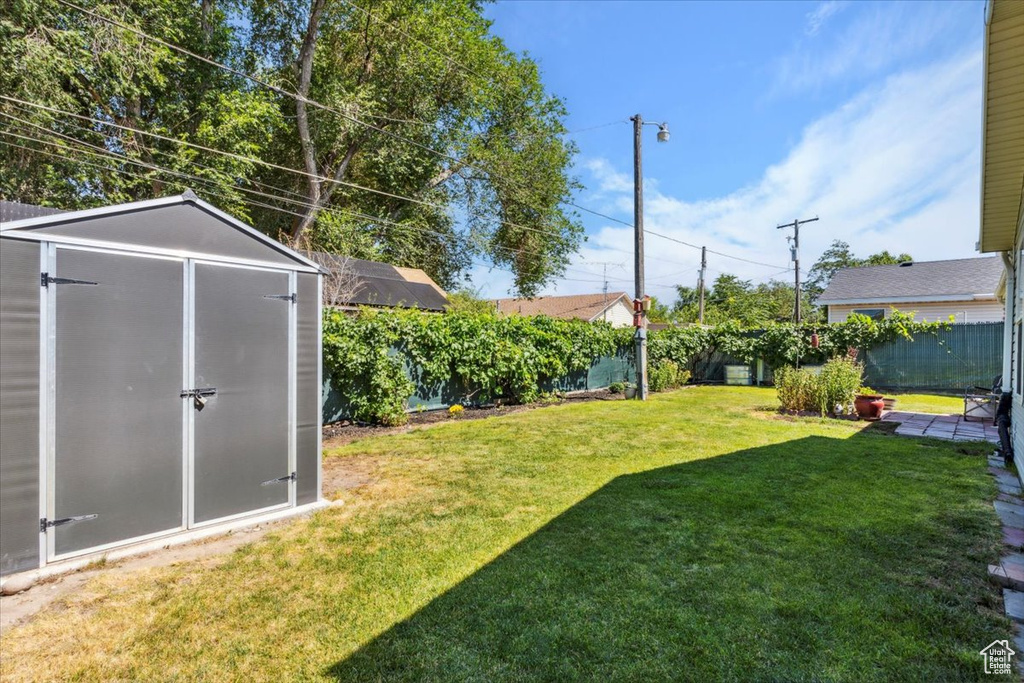 Fenced backyard with a storage shed